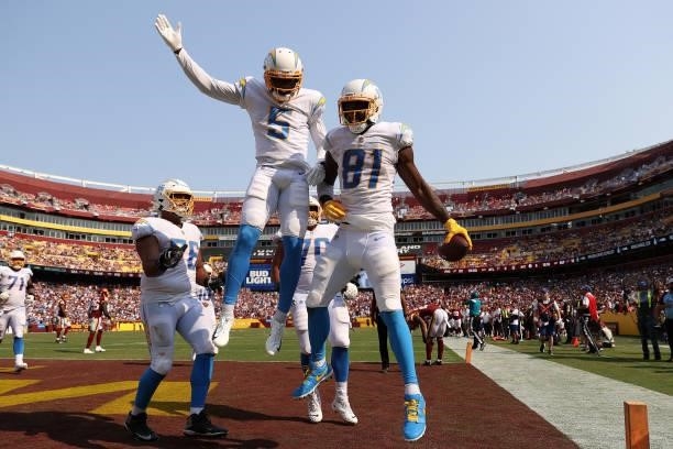 Mike Williams of the Los Angeles Chargers celebrates with teammates after catching a three yard touchdown reception during the fourth quarter against...