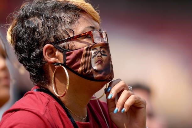 Washington Football Team fan look on while wearing masks during the game against the Los Angeles Chargers at FedExField on September 12, 2021 in...