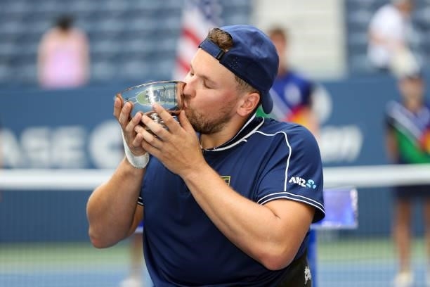 Dylan Alcott of Australia celebrates with the championship trophy after defeating Niels Vink of the Netherlands to complete a 'Golden Slam' during...