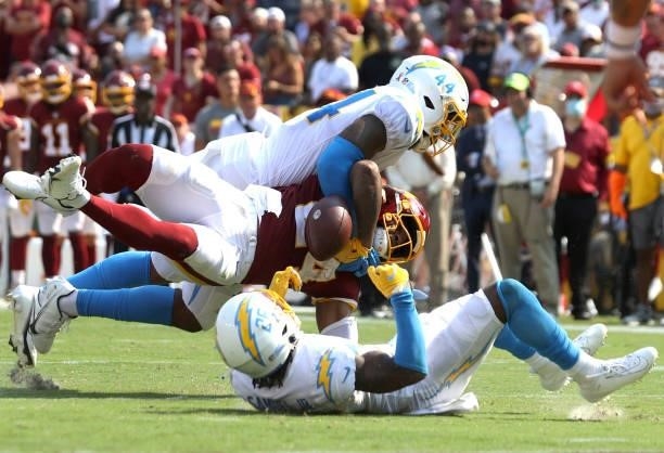 Antonio Gibson of the Washington Football Team fumbles against the Los Angeles Chargers during the fourth quarter at FedExField on September 12, 2021...