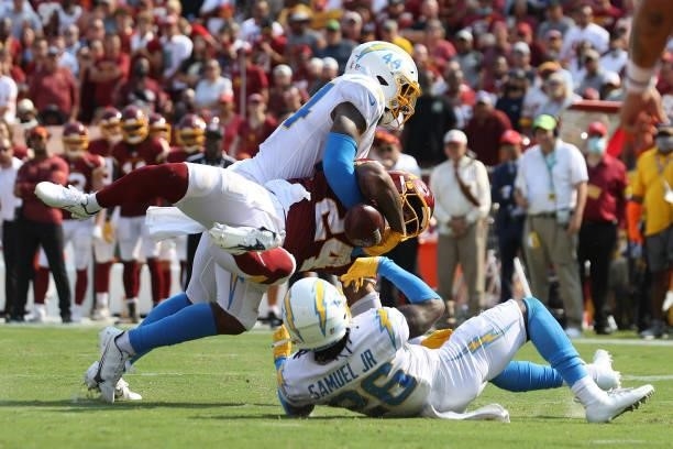 Antonio Gibson of the Washington Football Team fumbles against the Los Angeles Chargers during the fourth quarter at FedExField on September 12, 2021...