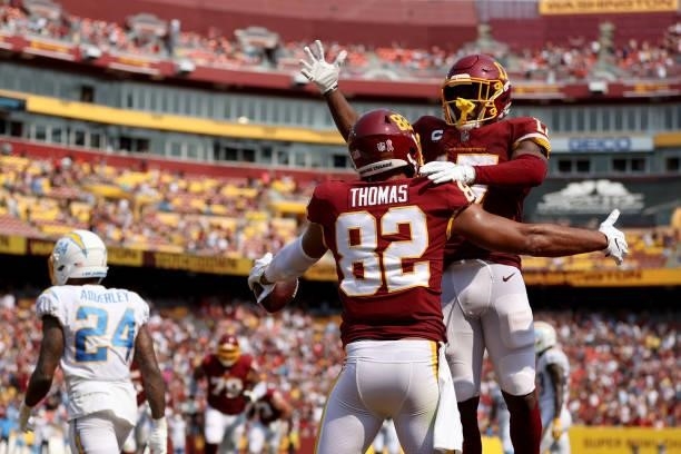 Logan Thomas of the Washington Football Team celebrates his touchdown reception against the Los Angeles Chargers with Terry McLaurin during the third...
