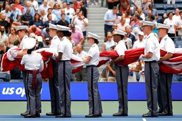 Members of the Military unfurl the American flag during the opening ceremony before the Men's Singles final match between Daniil Medvedev of Russia...