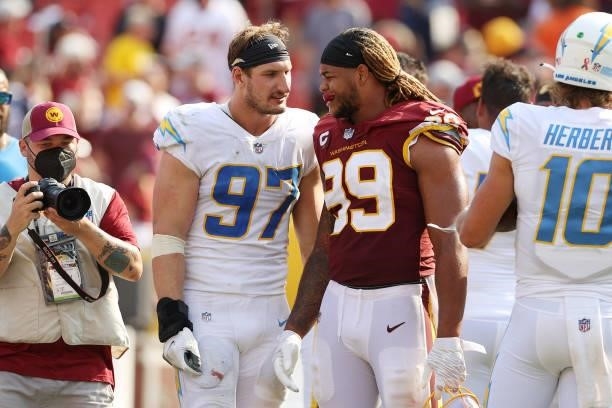 Chase Young of the Washington Football Team talks with Joey Bosa of the Los Angeles Chargers after the game at FedExField on September 12, 2021 in...