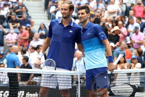 Daniil Medvedev of Russia and Novak Djokovic of Serbia smile at center court before the Men's Singles final match on Day Fourteen of the 2021 US Open...