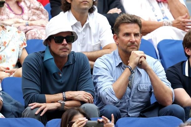 Actors Brad Pitt and Bradley Cooper watch the Men's Singles final match between Daniil Medvedev of Russia and Novak Djokovic of Serbia on Day...