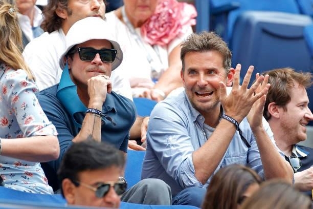 Actors Brad Pitt and Bradley Cooper watch the Men's Singles final match between Daniil Medvedev of Russia and Novak Djokovic of Serbia on Day...