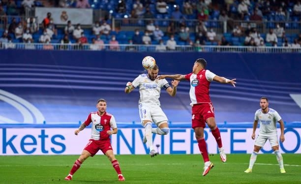 Karim Benzema of Real Madrid CF scores his team's second goal during the La Liga Santander match between Real Madrid CF and RC Celta de Vigo at...