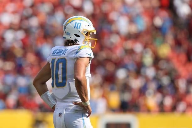 Justin Herbert of the Los Angeles Chargers reacts during the fourth quarter against the Washington Football Team at FedExField on September 12, 2021...