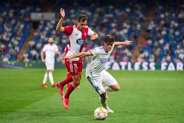 Miguel Guiterrez of Real Madrid CF competes for the ball with Augusto Soladi of Celta de Vigo during the La Liga Santander match between Real Madrid...