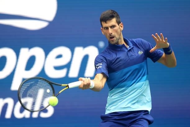 Novak Djokovic of Serbia returns the ball against Daniil Medvedev of Russia in the first set of the Men's Singles final match on Day Fourteen of the...