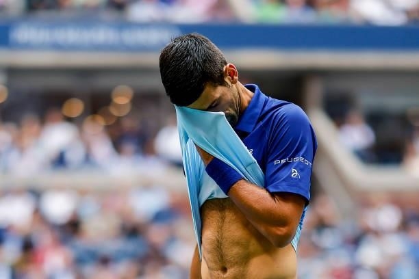 Novak Djokovic of Serbia dries his face as he plays against Daniil Medvedev of Russia during their Men's Singles final match on Day Fourteen of the...