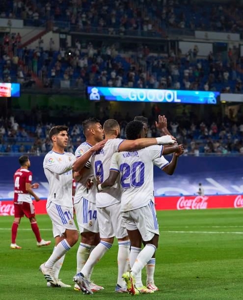 Karim Benzema of Real Madrid CF celebrates with team mates after scoring his team's fifth goal during the La Liga Santander match between Real Madrid...