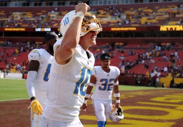 Justin Herbert of the Los Angeles Chargers celebrates following the victory against the Washington Football Team at FedExField on September 12, 2021...