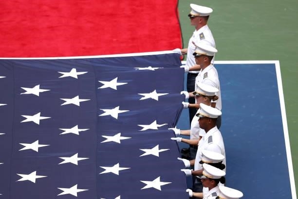 Members of the Military unfurl the American flag before the Men's Singles final match between Daniil Medvedev of Russia and Novak Djokovic of Serbia...