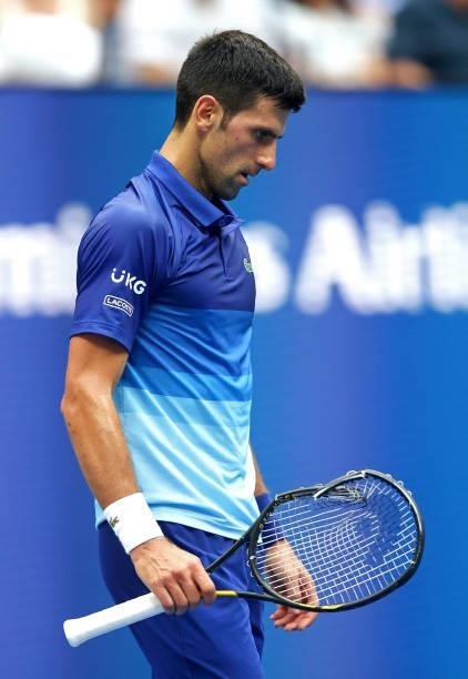 Novak Djokovic of Serbia holds his broken racket as he plays against Daniil Medvedev of Russia during their Men's Singles final match on Day Fourteen...