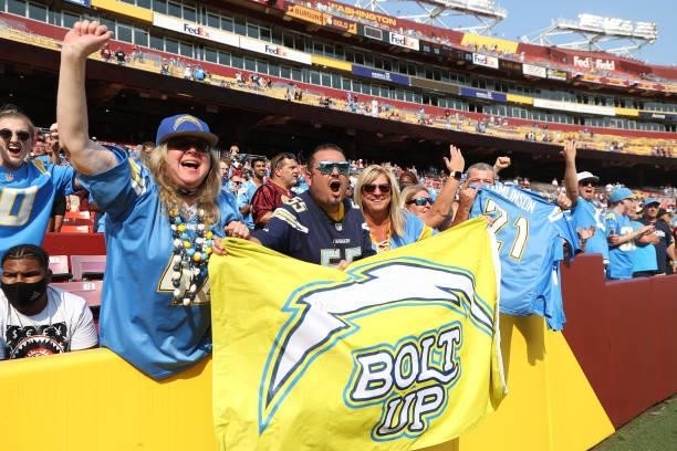 Los Angeles Chargers fans celebrate following their team's victory against the Washington Football Team at FedExField on September 12, 2021 in...