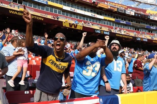 Los Angeles Chargers fans celebrate following their team's victory against the Washington Football Team at FedExField on September 12, 2021 in...