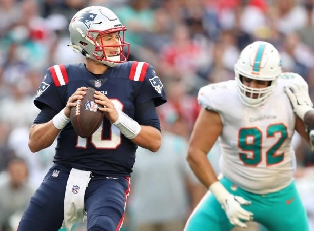 Mac Jones of the New England Patriots looks to pass during the first half against the Miami Dolphins at Gillette Stadium on September 12, 2021 in...