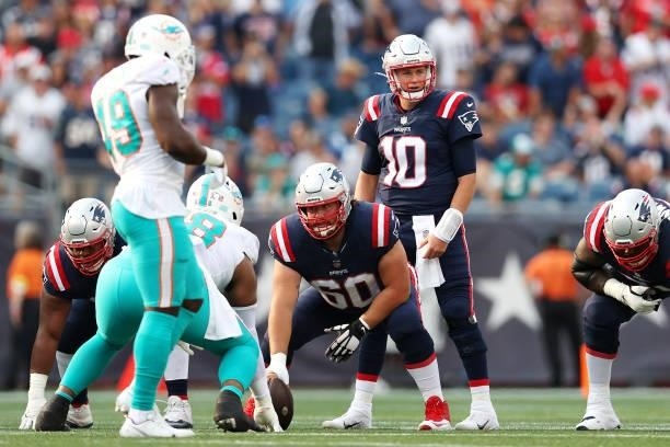 Mac Jones of the New England Patriots awaits the snap during the game against the Miami Dolphins at Gillette Stadium on September 12, 2021 in...