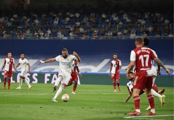 Karim Benzema of Real Madrid scores their team's first goal during the La Liga Santander match between Real Madrid CF and RC Celta de Vigo at Estadio...