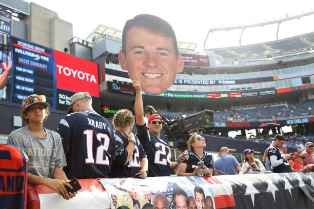 Fan of the New England Patriots holds up a Mac Jones fathead prior to the game against the Miami Dolphins at Gillette Stadium on September 12, 2021...