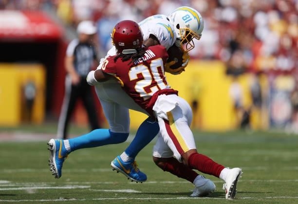 Mike Williams of the Los Angeles Chargers is hit by Bobby McCain of the Washington Football Team during the first quarter at FedExField on September...