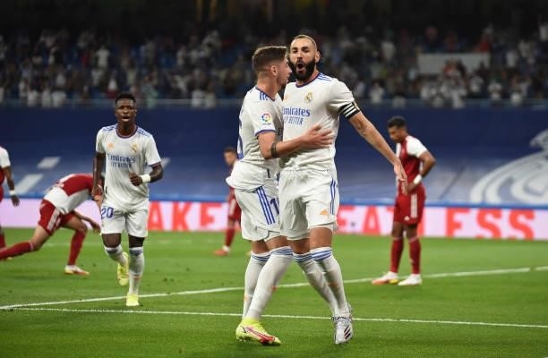 Karim Benzema of Real Madrid celebrates with teammate Federico Valverde after scoring their team's first goal during the La Liga Santander match...