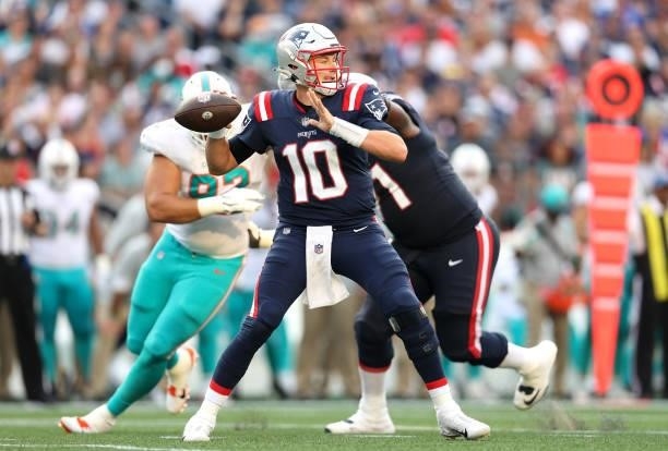 Mac Jones of the New England Patriots looks to pass against the Miami Dolphins during the first half at Gillette Stadium on September 12, 2021 in...