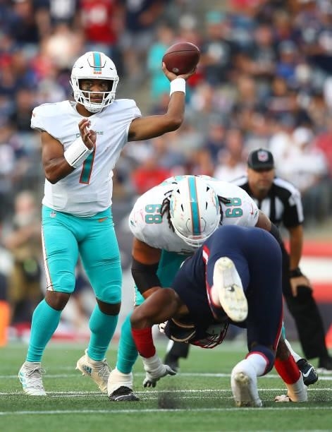 Tua Tagovailoa of the Miami Dolphins throws a pass during the first half against the New England Patriots at Gillette Stadium on September 12, 2021...
