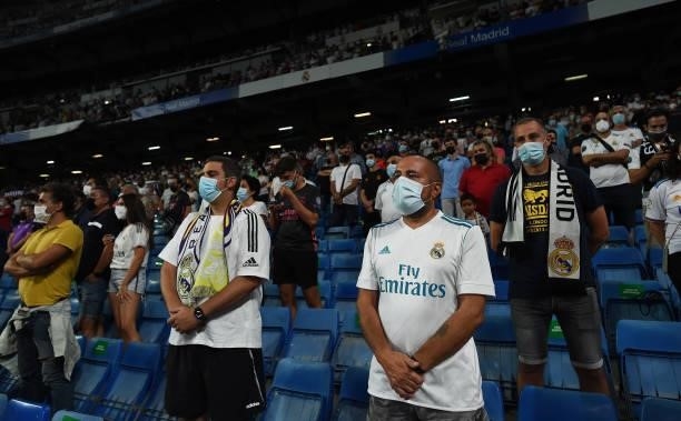 Real Madrid fans hold a minute of silence in honor of former club President Lorenzo Sanz prior to the start of the La Liga Santander match between...