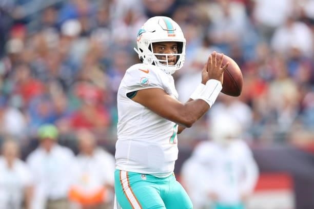 Tua Tagovailoa of the Miami Dolphins looks to pass during the first half against the New England Patriots at Gillette Stadium on September 12, 2021...