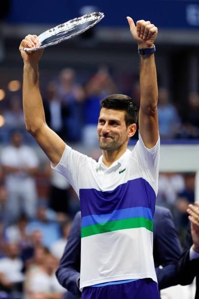 Novak Djokovic of Serbia celebrates with the runner-up trophy after being defeated by Daniil Medvedev of Russia during their Men's Singles final...