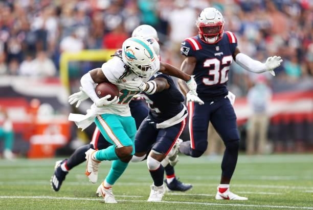Jaylen Waddle of the Miami Dolphins runs with the ball after a reception against the New England Patriots at Gillette Stadium on September 12, 2021...