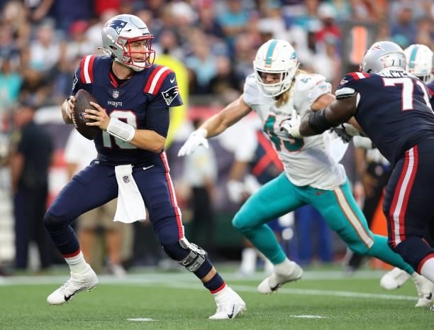 Mac Jones of the New England Patriots is looks to pass during the game against the Miami Dolphins at Gillette Stadium on September 12, 2021 in...