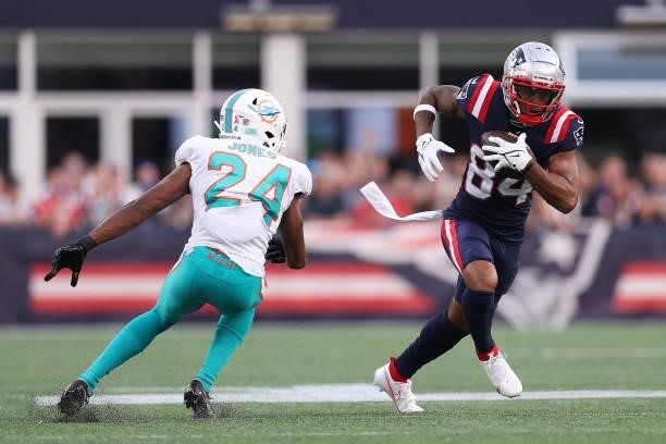 Kendrick Bourne of the New England Patriots runs with the ball after a reception against Byron Jones of the Miami Dolphins at Gillette Stadium on...