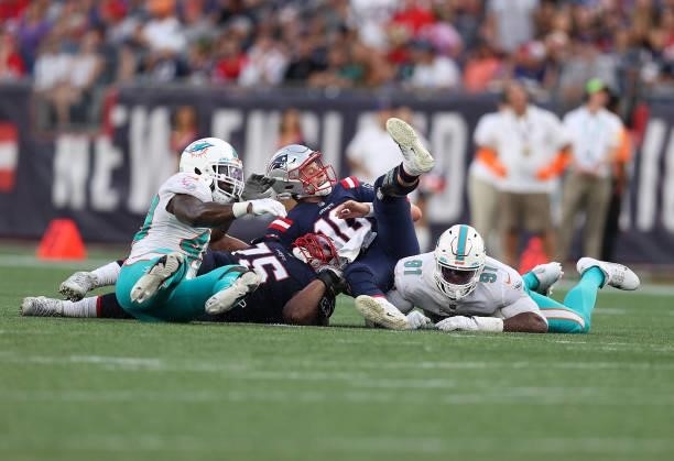 Mac Jones of the New England Patriots is tackled against the Miami Dolphins during the second half at Gillette Stadium on September 12, 2021 in...