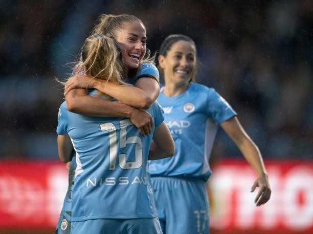 Janine Beckie of Manchester City celebrates with goalscorer Lauren Hemp after she scores during the Barclays FA Women's Super League match between...