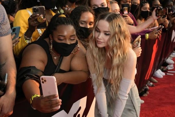 Dove Cameron poses for a selfie photo with fans during the 2021 MTV Video Music Awards at Barclays Center on September 12, 2021 in the Brooklyn...