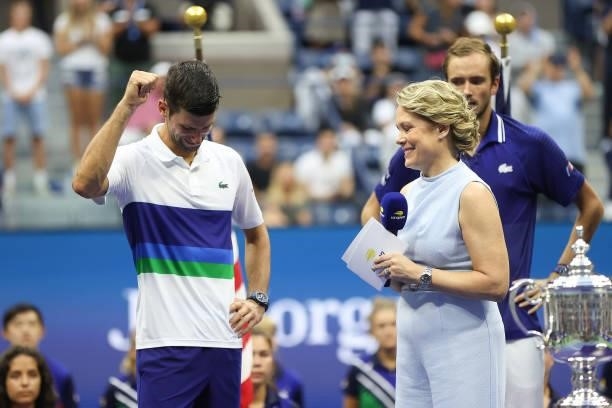 Runner up Novak Djokovic of Serbia speaks as Chris McKendry looks on during the trophy ceremony after being defeated by Daniil Medvedev of Russia...