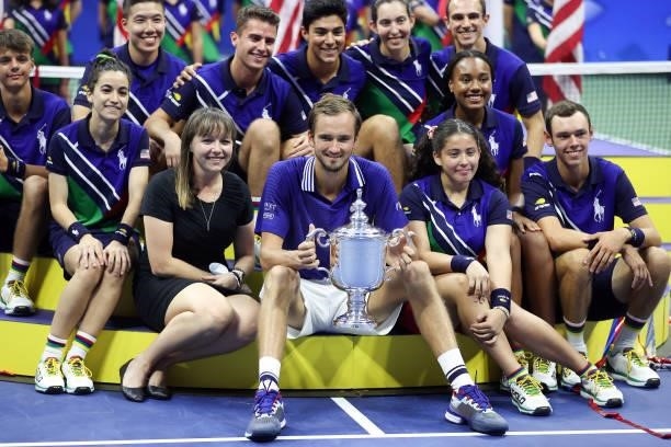 Daniil Medvedev of Russia celebrates with the championship trophy alongside ball kids after defeating Novak Djokovic of Serbia to win the Men's...