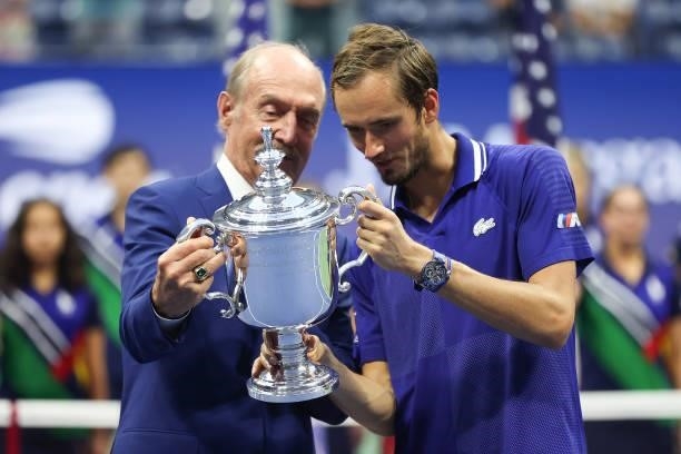 Daniil Medvedev of Russia looks with the championship trophy with former tennis player, Stan Smith, after defeating Novak Djokovic of Serbia to win...