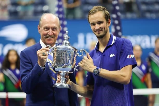 Daniil Medvedev of Russia holds with the championship trophy with former tennis player, Stan Smith, after defeating Novak Djokovic of Serbia to win...