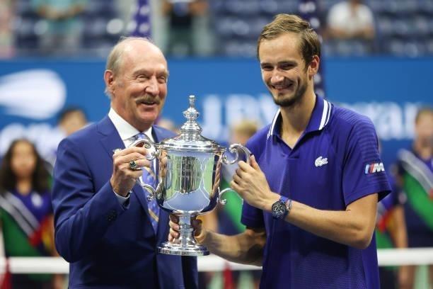 Daniil Medvedev of Russia holds with the championship trophy with former tennis player, Stan Smith, after defeating Novak Djokovic of Serbia to win...