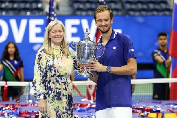 Daniil Medvedev of Russia celebrates with the championship trophy alongside Stacey Allaster, USTA Executive Chief, after defeating Novak Djokovic of...