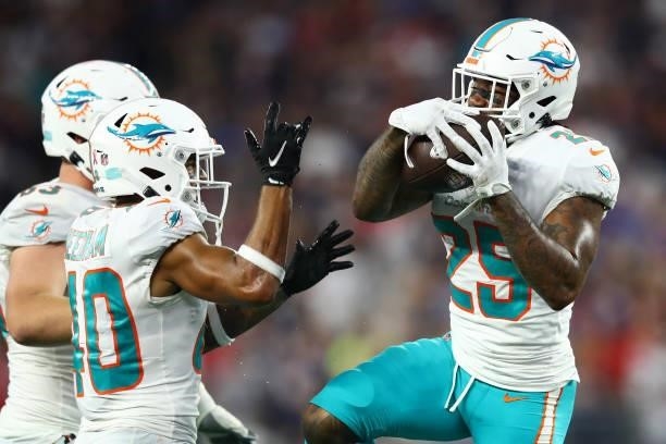 Xavien Howard of the Miami Dolphins celebrates his fumble recovery with Nik Needham during the second half against the New England Patriots at...