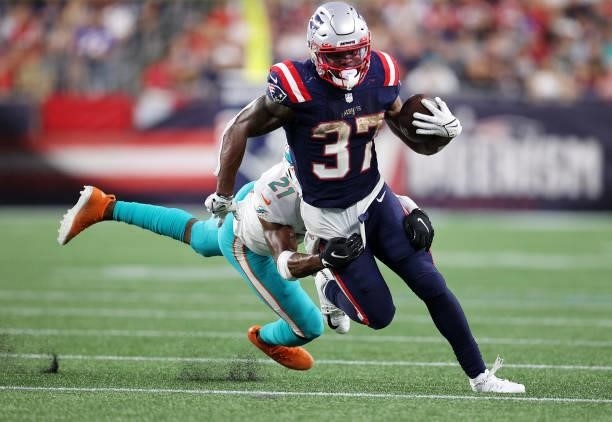 Damien Harris of the New England Patriots runs with the ball against the Miami Dolphins during the second half at Gillette Stadium on September 12,...