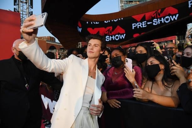 Shawn Mendes poses for a selfie photo with fans during the 2021 MTV Video Music Awards at Barclays Center on September 12, 2021 in the Brooklyn...