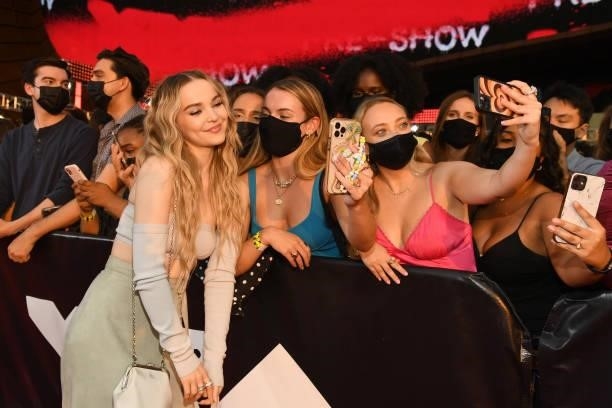 Dove Cameron poses for a selfie photo with fans during the 2021 MTV Video Music Awards at Barclays Center on September 12, 2021 in the Brooklyn...