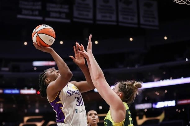 Forward Nneka Ogwumike of the Los Angeles Sparks shoots defended by forward Katie Lou Samuelson of the Seattle Storm in the first half at Staples...